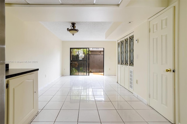 5808 W 26th Ave Unit 211, Hialeah, FL 33016 - empty room with light tile patterned floors and a textured ceiling