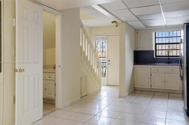 5808 W 26th Ave Unit 211, Hialeah, FL 33016 - kitchen featuring light tile patterned flooring, freestanding refrigerator, and decorative backsplash