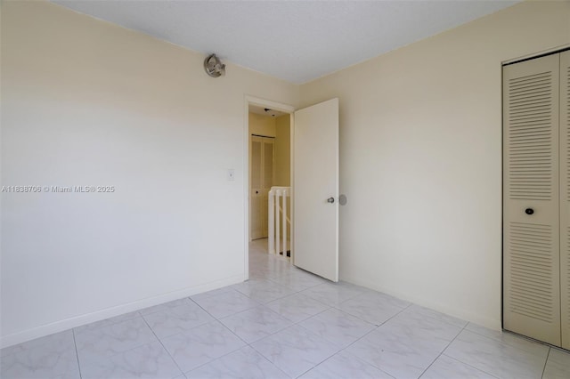 5808 W 26th Ave Unit 211, Hialeah, FL 33016 - unfurnished bedroom featuring a closet and baseboards
