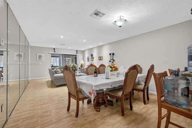 1600 Granfern Ave, West Palm Beach, FL 33415 - dining area with light wood finished floors, recessed lighting, and a textured ceiling