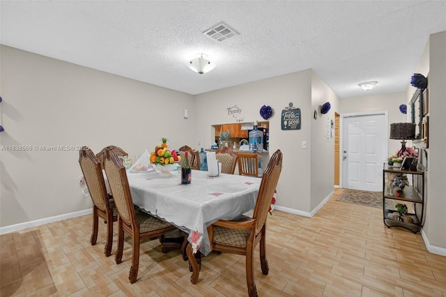 1600 Granfern Ave, West Palm Beach, FL 33415 - dining space featuring light wood-style flooring and a textured ceiling