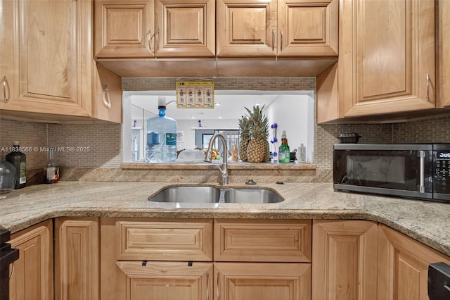 1600 Granfern Ave, West Palm Beach, FL 33415 - kitchen featuring decorative backsplash, light stone countertops, and light brown cabinetry
