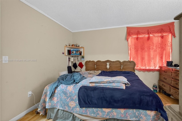 1600 Granfern Ave, West Palm Beach, FL 33415 - bedroom featuring wood finished floors, a textured ceiling, and ornamental molding
