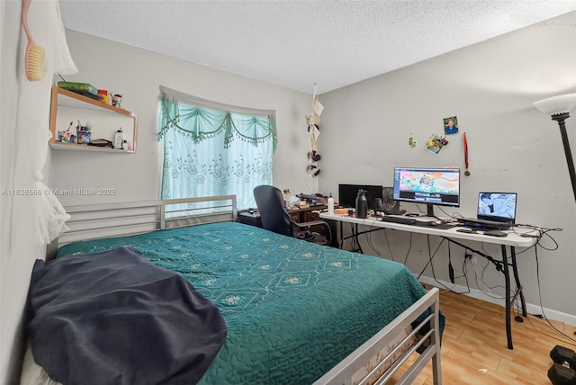 1600 Granfern Ave, West Palm Beach, FL 33415 - bedroom with wood finished floors, a textured ceiling, and a desk