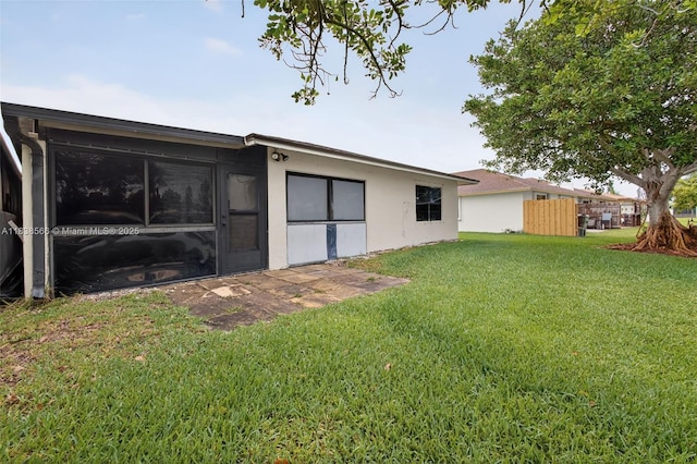 1600 Granfern Ave, West Palm Beach, FL 33415 - rear view of house featuring a yard and stucco siding