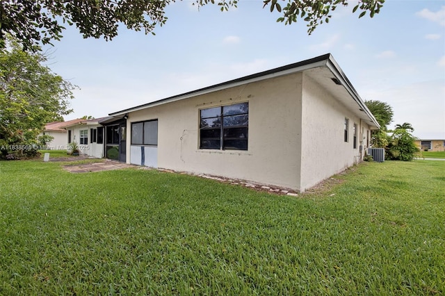 1600 Granfern Ave, West Palm Beach, FL 33415 - back of house featuring stucco siding and a lawn
