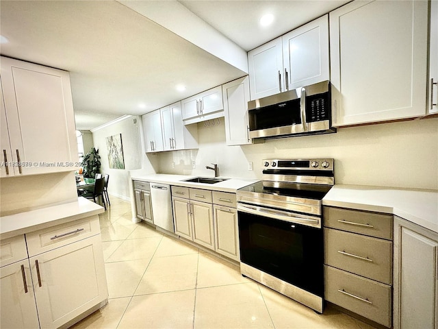 1080 94th St Unit 212, Bay Harbor Islands, FL 33154 - kitchen with stainless steel appliances, light countertops, recessed lighting, light tile patterned flooring, and white cabinetry
