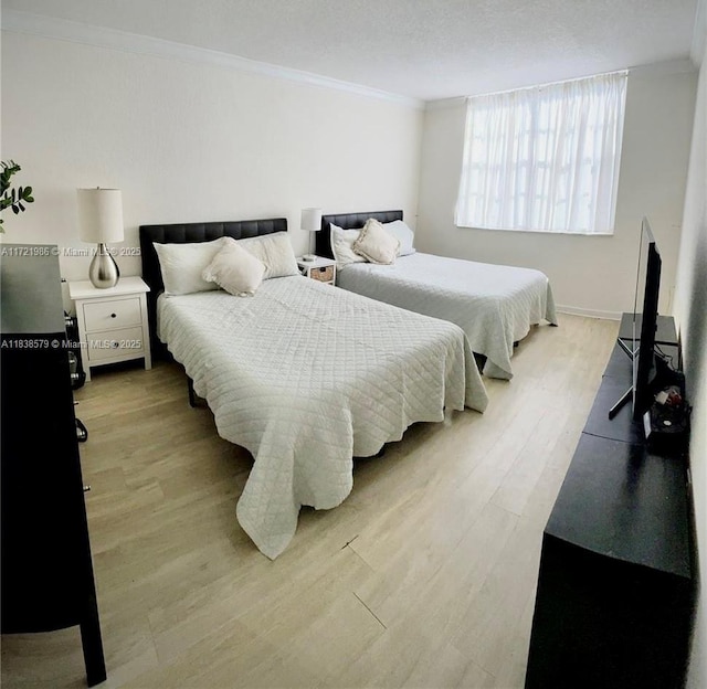 1080 94th St Unit 212, Bay Harbor Islands, FL 33154 - bedroom featuring ornamental molding and light wood-style floors