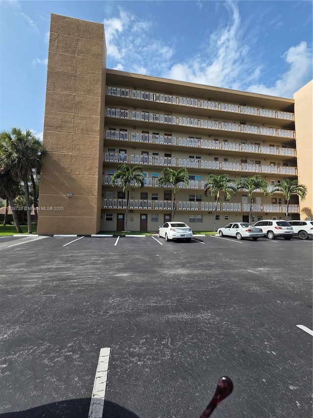 620 NE 12th Ave Unit 101, Hallandale Beach, FL 33009 - view of apartment building / complex featuring uncovered parking