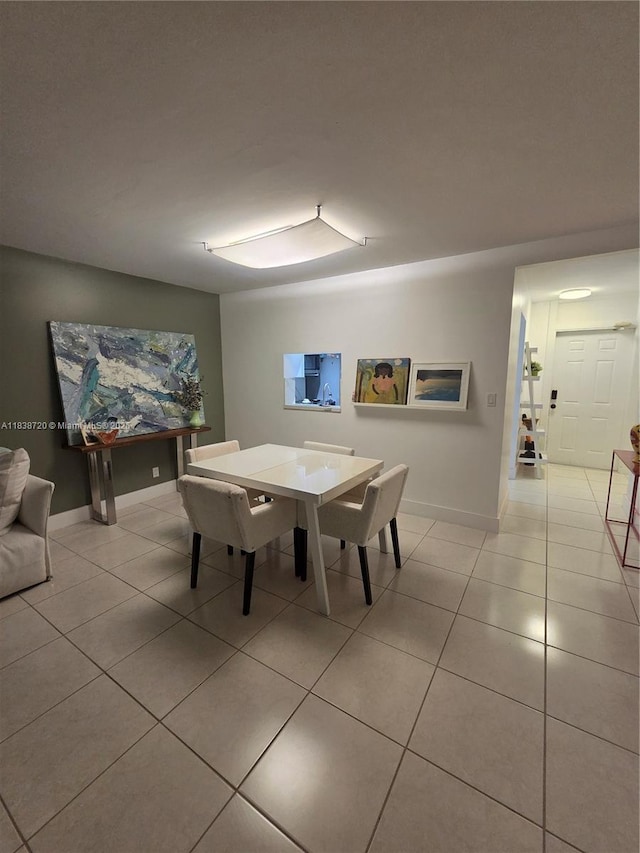 620 NE 12th Ave Unit 101, Hallandale Beach, FL 33009 - dining room with light tile patterned floors and baseboards