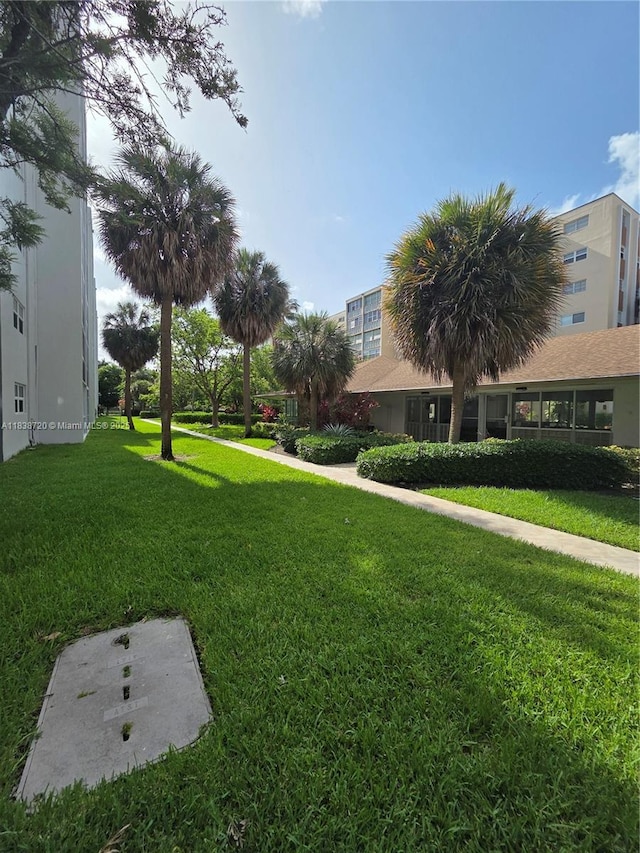 620 NE 12th Ave Unit 101, Hallandale Beach, FL 33009 - surrounding community with a lawn