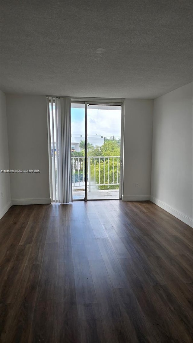 498 NW 165th St Rd Unit D-407, Miami, FL 33169 - unfurnished room with dark wood finished floors and a textured ceiling