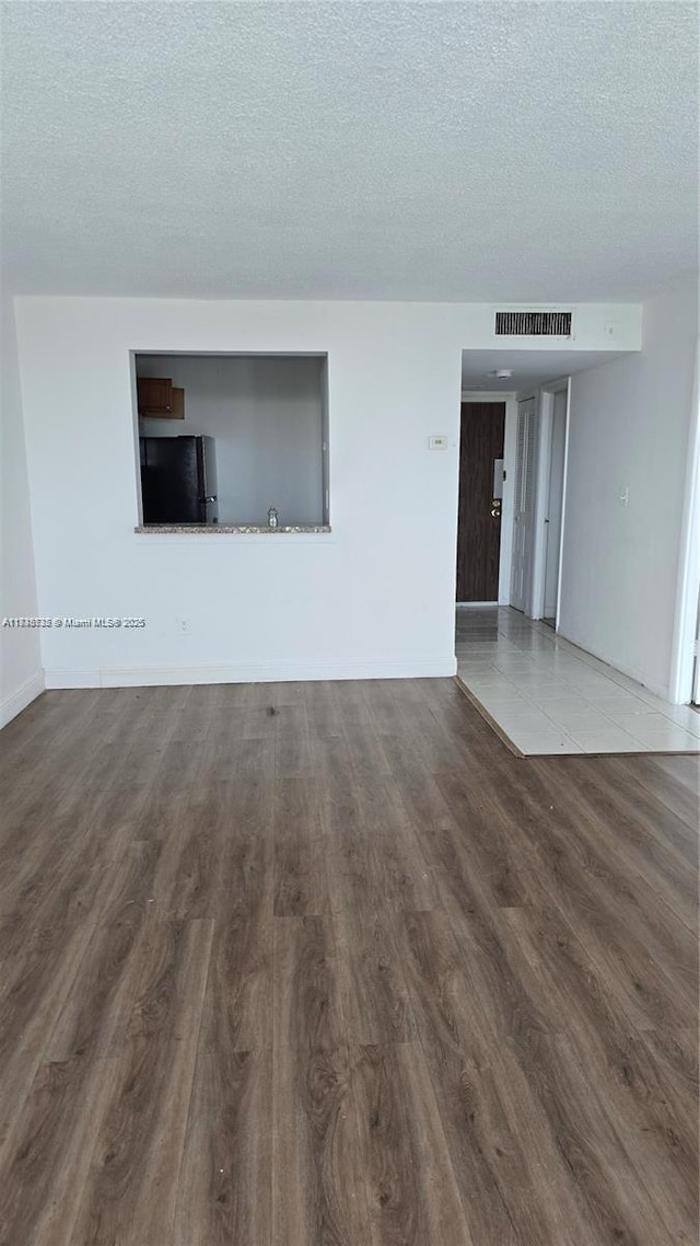 498 NW 165th St Rd Unit D-407, Miami, FL 33169 - unfurnished room featuring a textured ceiling and wood finished floors