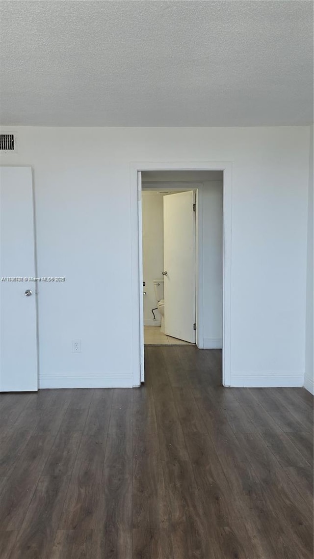 498 NW 165th St Rd Unit D-407, Miami, FL 33169 - spare room with dark wood-type flooring and a textured ceiling