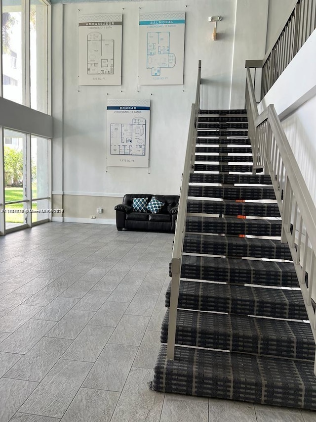 498 NW 165th St Rd Unit D-407, Miami, FL 33169 - stairs featuring a towering ceiling and baseboards