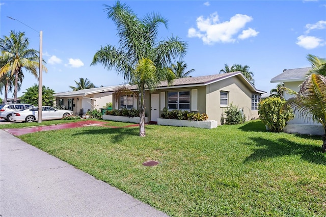 4938 NW 54th Ct, Tamarac, FL 33319 - ranch-style house with stucco siding and a front lawn