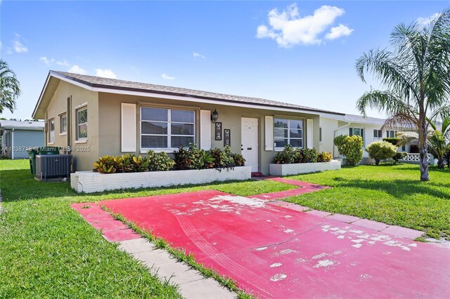 4938 NW 54th Ct, Tamarac, FL 33319 - view of front facade featuring stucco siding and a front yard