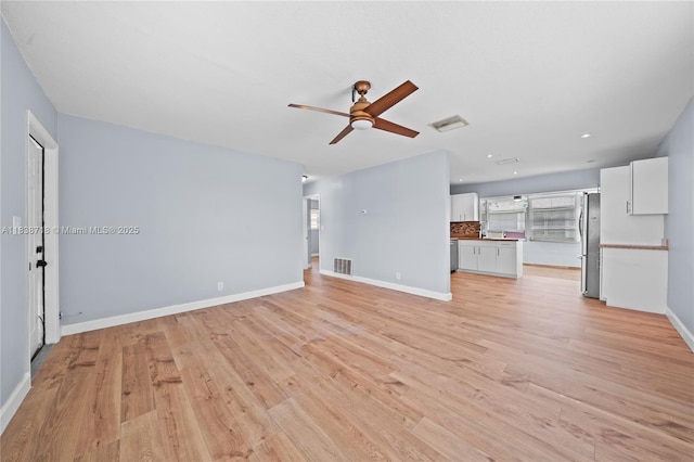 4938 NW 54th Ct, Tamarac, FL 33319 - unfurnished living room with a ceiling fan, plenty of natural light, light wood finished floors, and recessed lighting