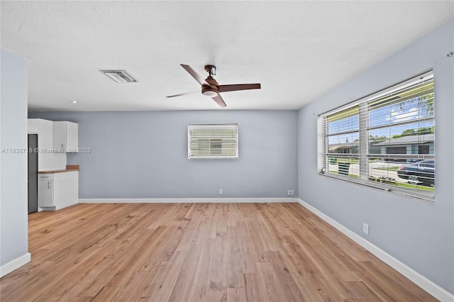 4938 NW 54th Ct, Tamarac, FL 33319 - unfurnished living room featuring light wood finished floors and ceiling fan