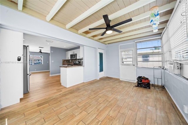 4938 NW 54th Ct, Tamarac, FL 33319 - kitchen with a ceiling fan, appliances with stainless steel finishes, backsplash, light wood finished floors, and a wood ceiling with exposed beams