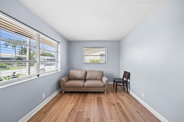 4938 NW 54th Ct, Tamarac, FL 33319 - living area with light wood-style flooring and healthy amount of natural light