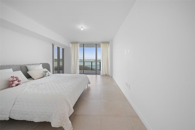 1135 103rd St Unit 702, Bay Harbor Islands, FL 33154 - bedroom featuring floor to ceiling windows, access to outside, and light tile patterned floors