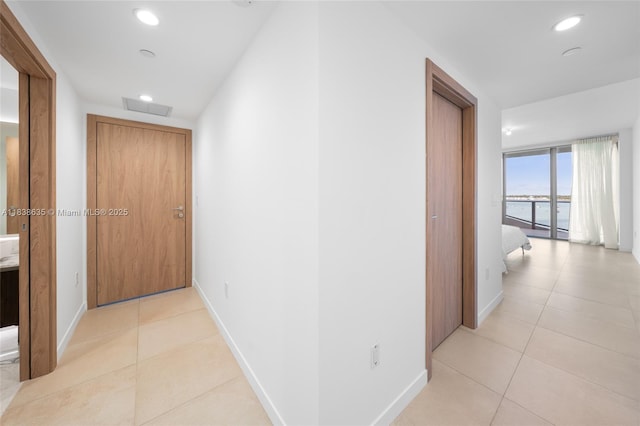 1135 103rd St Unit 702, Bay Harbor Islands, FL 33154 - corridor with light tile patterned floors and recessed lighting