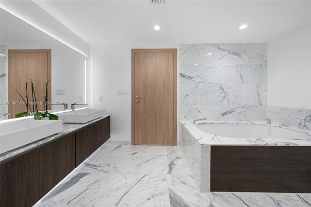 1135 103rd St Unit 702, Bay Harbor Islands, FL 33154 - bathroom with double vanity, a garden tub, recessed lighting, and marble tiled flooring