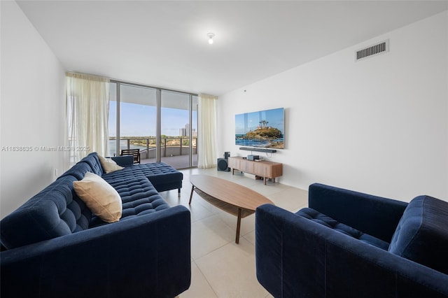 1135 103rd St Unit 702, Bay Harbor Islands, FL 33154 - living room featuring light tile patterned floors and floor to ceiling windows