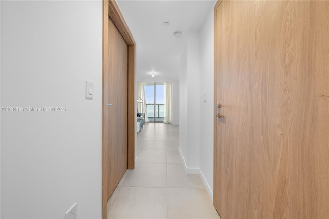 1135 103rd St Unit 702, Bay Harbor Islands, FL 33154 - corridor featuring light tile patterned floors and a wall of windows