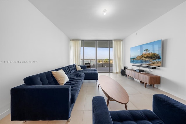 1135 103rd St Unit 702, Bay Harbor Islands, FL 33154 - living room featuring light tile patterned floors and a wall of windows