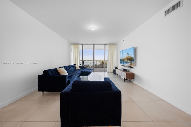 1135 103rd St Unit 702, Bay Harbor Islands, FL 33154 - living area with expansive windows and light tile patterned flooring