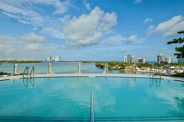 1135 103rd St Unit 702, Bay Harbor Islands, FL 33154 - view of pool with a view of skyline and a water view
