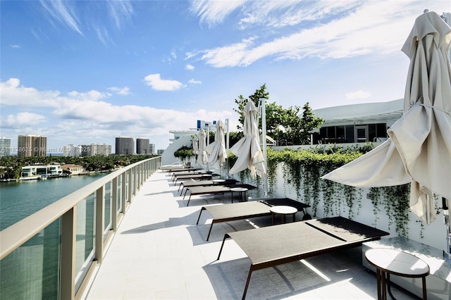 1135 103rd St Unit 702, Bay Harbor Islands, FL 33154 - view of patio / terrace with a water view and a city view