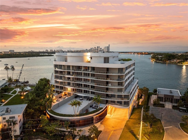 1135 103rd St Unit 702, Bay Harbor Islands, FL 33154 - property at dusk with a water view and a view of apartment building / complex