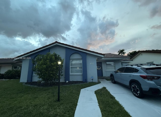 1060 NW 128th Ct, Miami, FL 33182 - single story home with stucco siding, a front yard, and concrete driveway