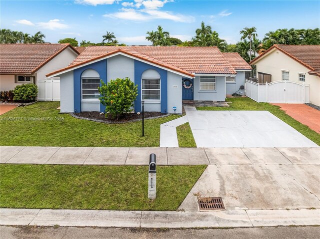1060 NW 128th Ct, Miami, FL 33182 - ranch-style house with a tiled roof, a gate, a front lawn, stucco siding, and driveway