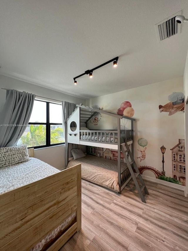 8813 Antarus Dr Unit 8813, Lake Worth, FL 33467 - bedroom with wood finished floors and rail lighting
