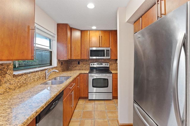2794 SW 22nd Ave, Miami, FL 33133 - kitchen with appliances with stainless steel finishes, brown cabinets, decorative backsplash, light stone counters, and recessed lighting