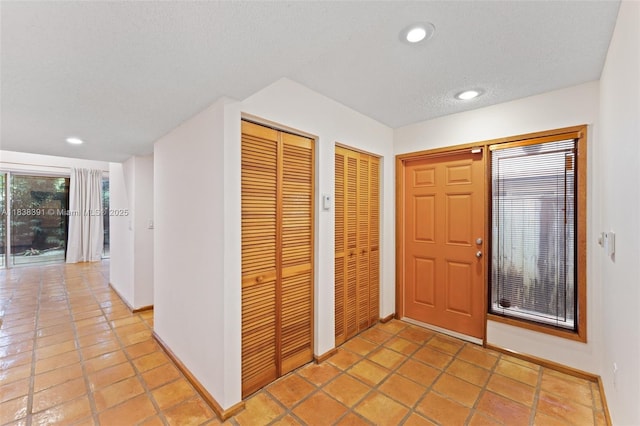 2794 SW 22nd Ave, Miami, FL 33133 - entrance foyer with recessed lighting, light tile patterned flooring, and a textured ceiling