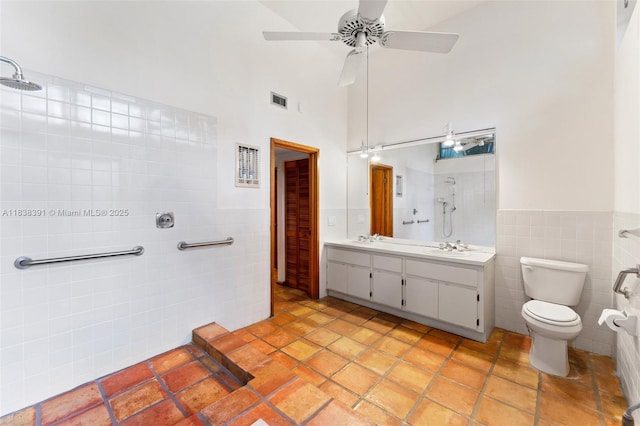 2794 SW 22nd Ave, Miami, FL 33133 - bathroom featuring tile walls, double vanity, a shower, a towering ceiling, and ceiling fan