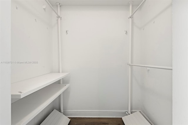 5077 NW 7th St Unit Ph15, Miami, FL 33126 - spacious closet featuring dark wood finished floors