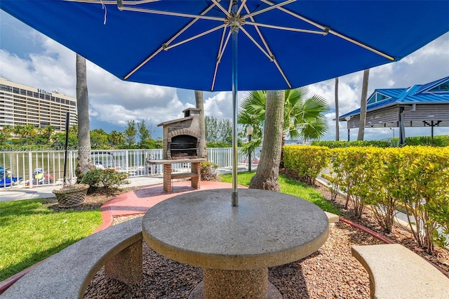 5077 NW 7th St Unit Ph15, Miami, FL 33126 - view of patio featuring an outdoor stone fireplace