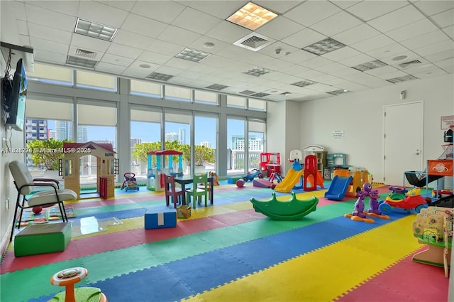 1111 SW 1st Ave Unit 2823-N, Miami, FL 33130 - recreation room with tile patterned floors, a drop ceiling, and a city view