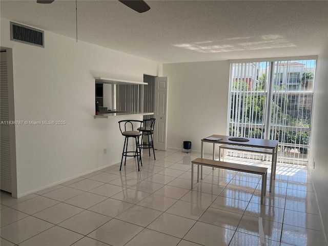 200 172nd St Unit 420, Sunny Isles Beach, FL 33160 - dining space with tile patterned flooring and a textured ceiling