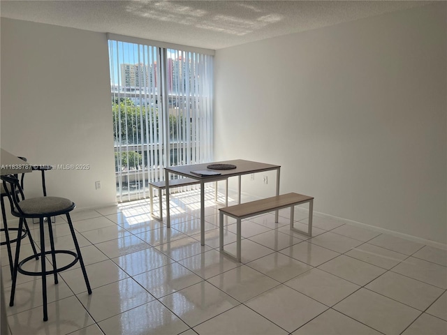 200 172nd St Unit 420, Sunny Isles Beach, FL 33160 - dining room featuring light tile patterned flooring, a textured ceiling, and floor to ceiling windows