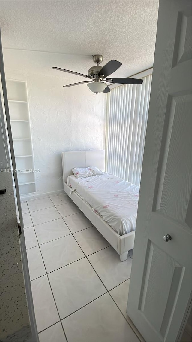 200 172nd St Unit 420, Sunny Isles Beach, FL 33160 - bedroom featuring light tile patterned floors, a textured ceiling, and ceiling fan