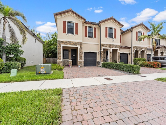 11901 SW 150th Pl, Miami, FL 33196 - mediterranean / spanish-style house with stone siding, decorative driveway, an attached garage, stucco siding, and a tiled roof