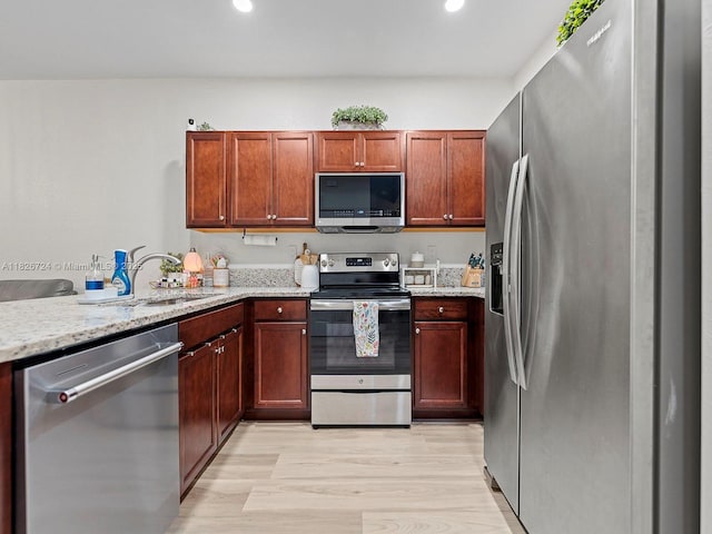 11901 SW 150th Pl, Miami, FL 33196 - kitchen with appliances with stainless steel finishes, light wood-style floors, light stone counters, and recessed lighting