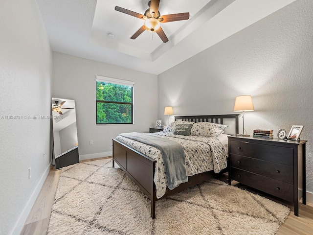 11901 SW 150th Pl, Miami, FL 33196 - bedroom featuring wood finished floors, a raised ceiling, and a ceiling fan